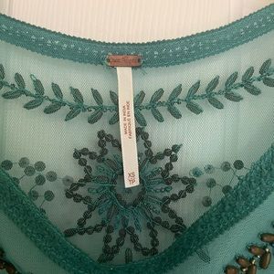 Beautiful green Free People top with bead details.